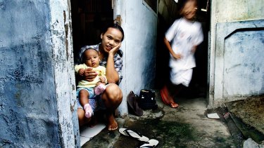 A mother and child in Jakarta in 2002, the year of the Indonesian default.