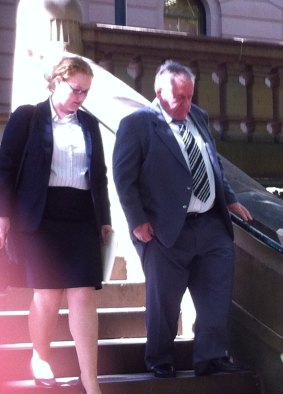 Bus driver Robert Reid leaves court with his daughter on Monday.