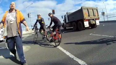 The truck driver confronts the cyclist at the scene.  