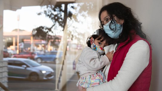 Leidy Castro Meneses with her daughter, Sofia, in the lobby of her apartment building in Yagoona. She is alone during Sydney's lockdown, because her husband is in Colombia visiting family. The Canterbury-Bankstown LGA is a hotspot during the latest Covid-19 outbreak, and the residents have tighter restrictions than elsewhere in Sydney. 6th August 2021 Photo: Janie Barrett
