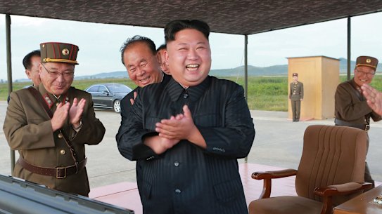 North Korean leader Kim Jong-un, centre, celebrates his latest missile test launch on Friday. Independent journalists were not given access.