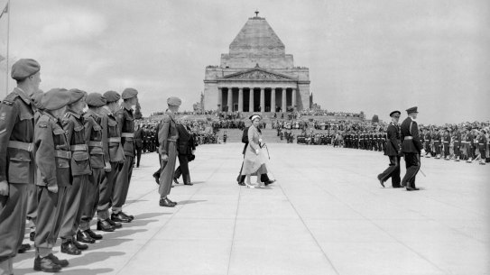 After dedicating the forecourt at the Shrine of Remembrance in Melbourne, Victoria, The Queen walks across it to inspect the eternal flame. 28th February 1954. 
