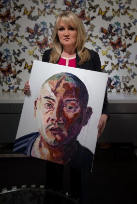 A flair for art: Melbourne pastor Christie Buckingham holds Myuran Sukumaran's portrait of Andrew Chan.