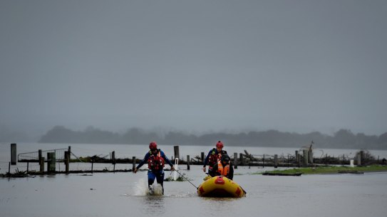 A SES crew make their way through the flood waters in Shoalhaven Heads, NSW.