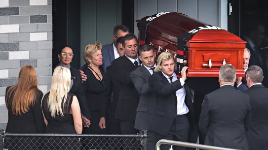 The coffin of Shane Warne is carried out by his son Jackson and brother Jason.