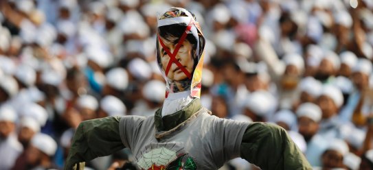 An effigy of Myanmar's Foreign Minister and Nobel Peace laureate Aung San Suu Kyi is held high before being burnt at a protest in Dhaka, Bangladesh, in November.