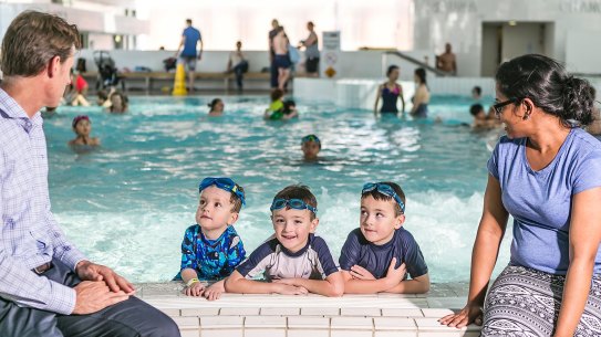 Justin Scarr of Royal Life Saving with Fiji delegate Devina Nand visit Ian Thorpe Pool in Sydney as part of an international delegation visiting Australia to learn about drowning prevention. Scarr is pictured with three-year-old Jacob Wright and six-year-old twins Joey and Ben of Pyrmont. 

