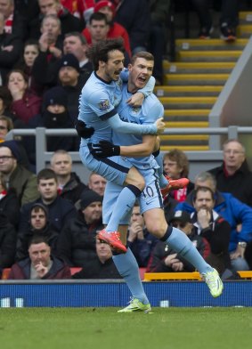 David Silva congratulates Edin Dzeko on his goal for Manchester City at Anfield on Sunday.