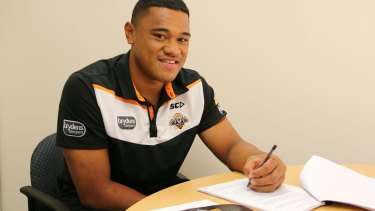 Done deal: Mosese Suli signs his $1.3 million contract.