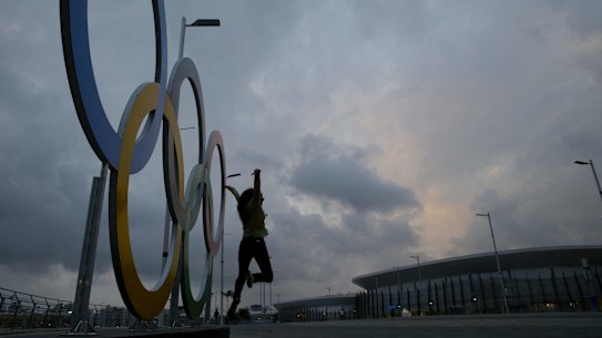 Monalisa Paduin poses for photos in front of the Olympic rings  at Olympic Park in Rio. Two car accidents have taken place on the road that access the park in the last few days.