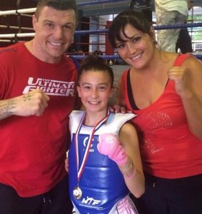 Jasmine Parr, 11, with her world-champion parents John Wayne and Angela Parr.
