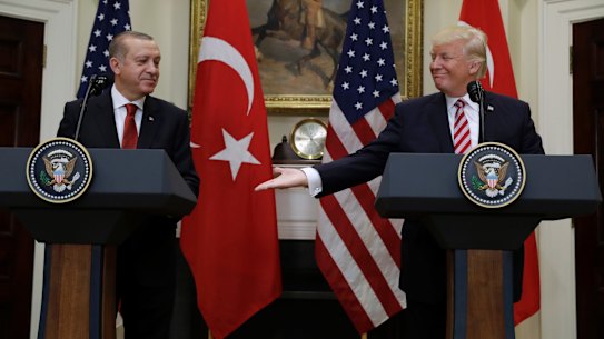 US President Donald Trump reaches to shake hands with Turkish President Recep Tayyip Erdogan in Washington on Tuesday.