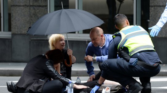 Bystanders comforted the injured in Bourke Street.
