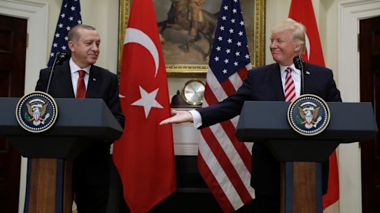 President Donald Trump reaches to shake hands with Turkish President Recep Tayyip Erdogan in Washington on Tuesday.