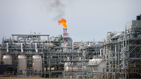A flame blazes on top of flare stacks at a plant at the Queensland Curtis Liquefied Natural Gas Project.