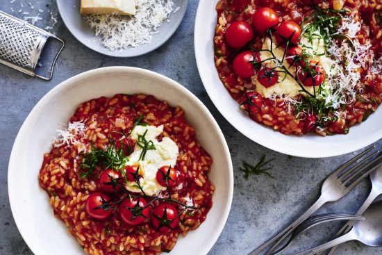 Tomato risotto finished with stracciatella and parmigiano cheeses.