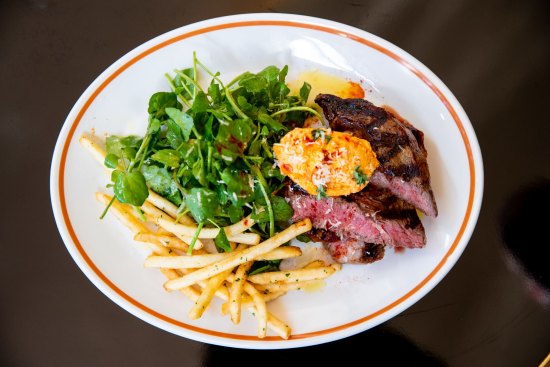 Grilled-and-sliced black angus rib eye topped with tomato butter with a good handful of watercress.