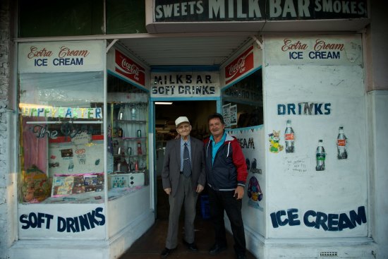 George Poulos with his son Nik in Summer Hill. George served his customers dressed in a suit and tie every day.