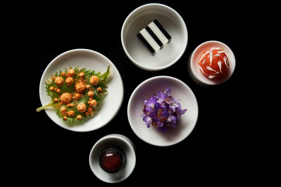 Clockwise from left: Tempura oba with smoked ama ebi (prawn); egg white tofu and smoked eggplant dashi; saikou salmon with smoked roe and sudachi (citrus); bonito, dashi cream, purple yam; tuna with yuzu kosho.