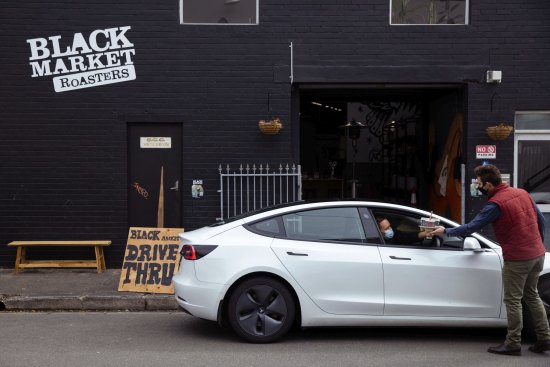 Spirited success: Black Market's Angus Nichol serves a customer at the drive-through.