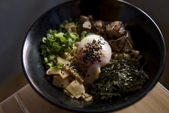 The original mazesoba includes chunks of house-made pork belly chashu, a runny onsen egg and a dusting of spring onion.