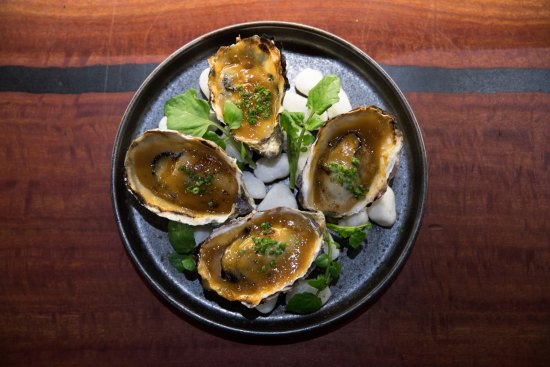 Oysters grilled in the shell and dressed with a rich yuzu miso cream.