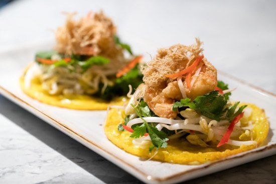 Small banh xeo pancakes with bean sprouts, galangal, rau ram (Vietnamese mint), pork floss and king prawn.