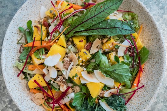 Mango salad bowl with papaya and peanuts.