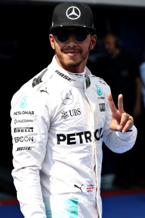 Lewis Hamilton of Great Britain and Mercedes GP celebrates his pole position.
