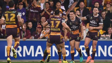 James Roberts of the Broncos celebrates scoring a try against the Roosters at Suncorp Stadium on Thursday night.