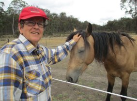 The late Annie Dixon, fulfilling her dying wish to pat a wild horse, with Roger at the New England Brumby Sanctuary.