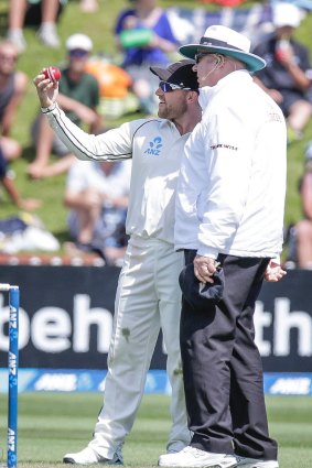 New Zealand captain Brendon McCullum expresses concern at the shape of the ball to umpire Steve Davis.

