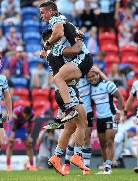 Valentine Holmes celebrates another try for the Sharks in Sunday's 62-0 flogging of the Knights at Hunter Stadium. 