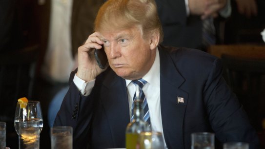 Republican presidential candidate Donald Trump on his mobile phone during a lunch stop in South Carolina. He's been picked  by an oil baron as a "business leader's candidate".