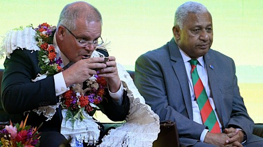 Scott Morrison attends a traditional ceremony of welcome with the Prime Minister of Fiji Frank Bainimarama in Suva.