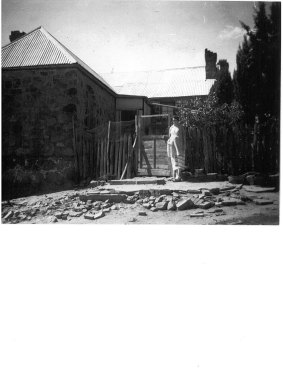 Mrs O'Brien outside Blundells Cottage in 1956. Mrs O'Brien boarded there with her husband.