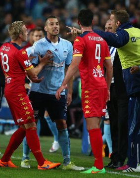 Jimmy Jeggo of Adelaide United restrains Nikola Petkovic of Sydney FC as he exchanges heated words with Dylan McGowan.