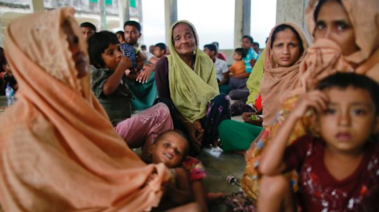Members of Myanmar's Muslim Rohingya minority sit in a temporary shelter at Shah Porir Deep.