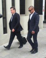 Former Eagle Daniel Kerr (right) arrives at the Perth Magistrates Court.