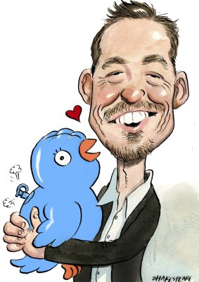 Jamie McIntyre holds a blow-up Twitter logo. 