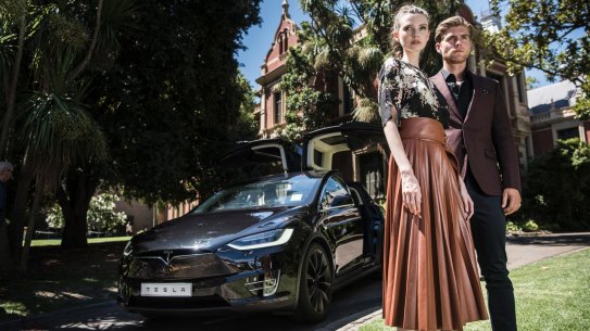 MELBOURNE, AUSTRALIA - FEBRUARY 15: Models from Myer Melbourne Autumn / Winter Fashion launch which is being held at Melbourne University pose with the new Tesla Model X in front of one of the campus buildings. Myer is launching a Tesla showroom in its Melbourne store meaning that from Friday, you will be able to buy a car from a department store. Part of broader innovation push at Myer. February 15, 2017 in Melbourne, Australia. (Photo by Josh Robenstone/Fairfax Media)