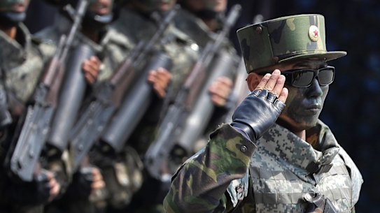 'Our ultimate dignity': North Korean commandoes march across Kim Il-sung Square during a military parade on Saturday.