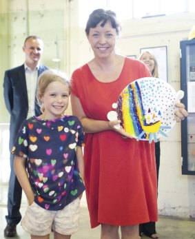 Audrey Hickman, 7, with her winning design from the The Canberra Times Kids' Glass Design Competition at the Canberra Glassworks, and artist Lisa Cahill. 