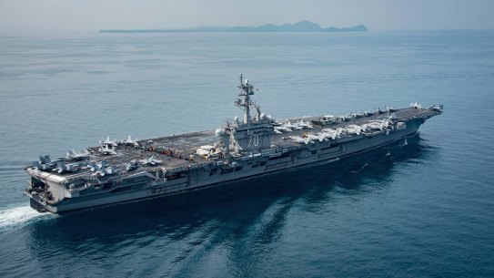 In this Saturday, April 15, 2017 photo released by the U.S. Navy, the aircraft carrier USS Carl Vinson transits the Sunda Strait between the Indonesian islands of Java and Sumatra.