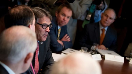 Energy Secretary Rick Perry, centre left, accompanied by Budget Director Mick Mulvaney, centre, and Scott Pruitt, right, speaks during a cabinet meeting last month.