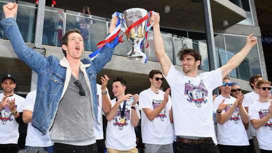 Howling success : Bulldogs Easton Wood and Robert Murphy show the trophy to the crowd during the grand final celebrations at Whitten Oval on Sunday. 