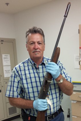 Detective Michael Ciesynski holds the long shotgun which rock legend Kurt Cobain used to kill himself on April 8, 1994.