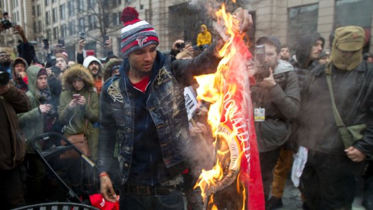 A protester burns a Donald Trump shirt during a demonstration in downtown Washington on January 20.