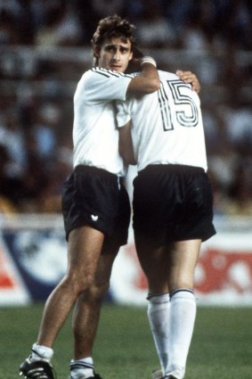 Alumni: West Germany's Pierre Littbarski consoles teammate Uli Stielike after he missed a penalty in the semi-final shoot-out  against France at the 1982 World Cup finals.
