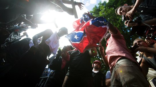 Counter-protesters tear a Confederate flag during the white nationalist rally, on Saturday. 